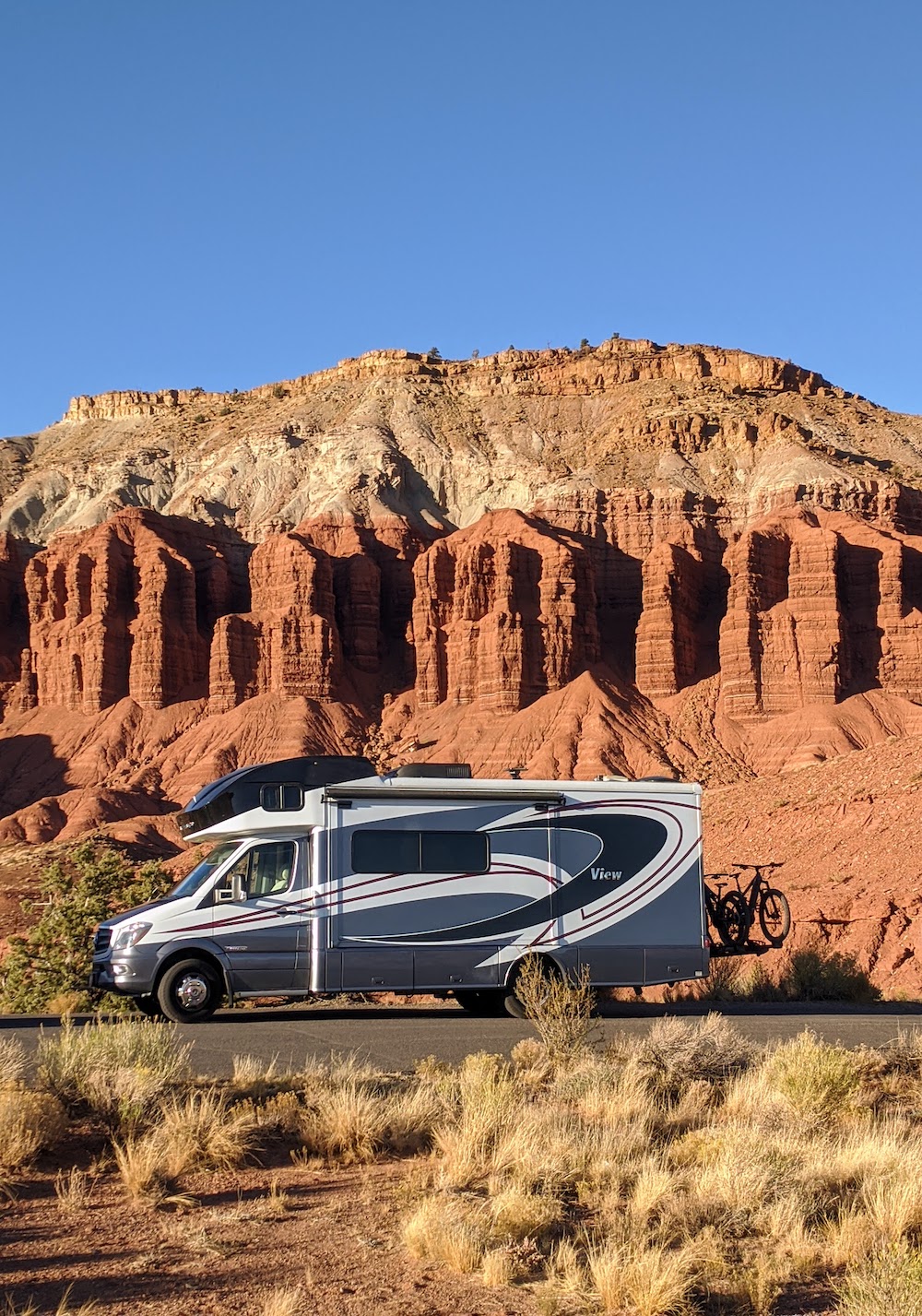 RV in Capitol Reef Park with orange rock background