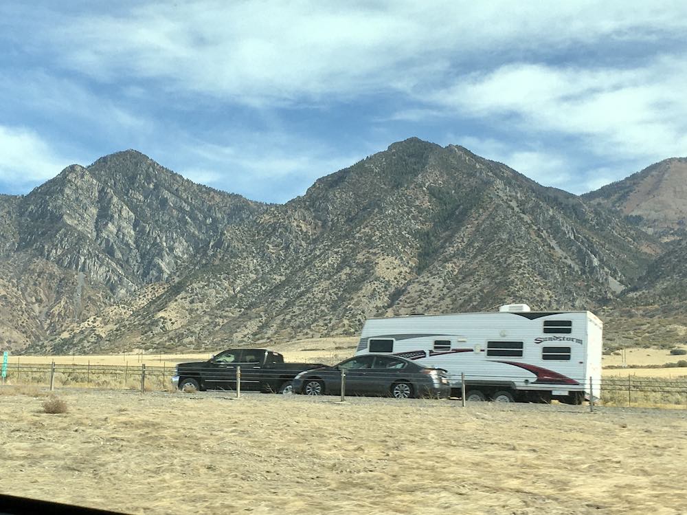 dispersed camping trailer and mountain backdrop