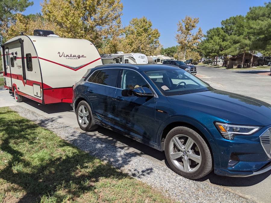 etron EV at campground with travel trailer in tow