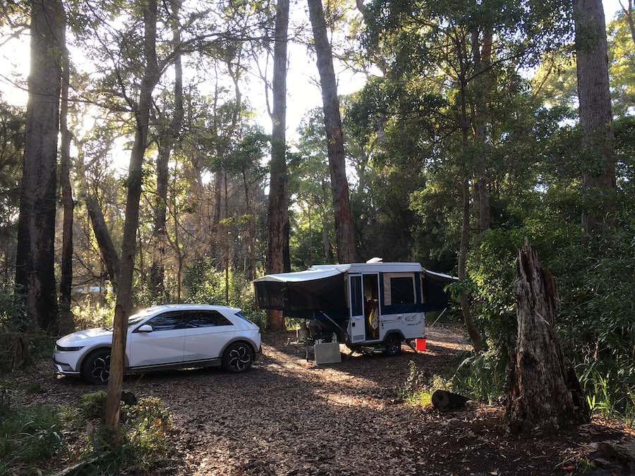 Ioniq EV towing pop out trailer in wooded campground