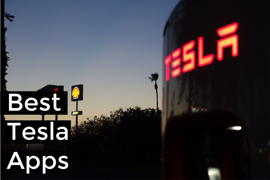 Best Tesla Apps - illuminated Tesla sign at night charging stop with palm tree and gas station in background