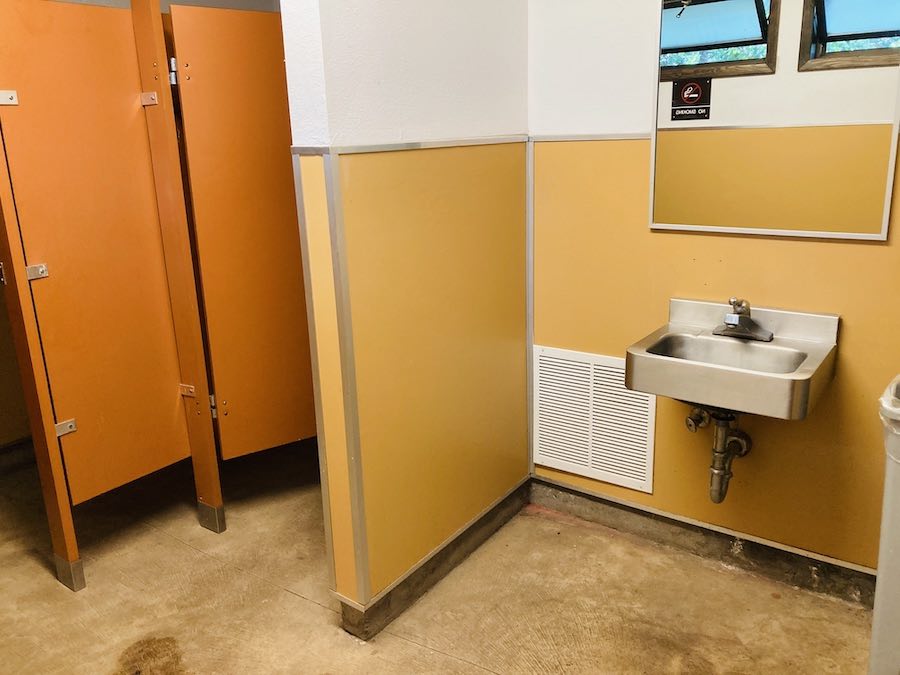 bathroom at group RV site with two stalls, sink
