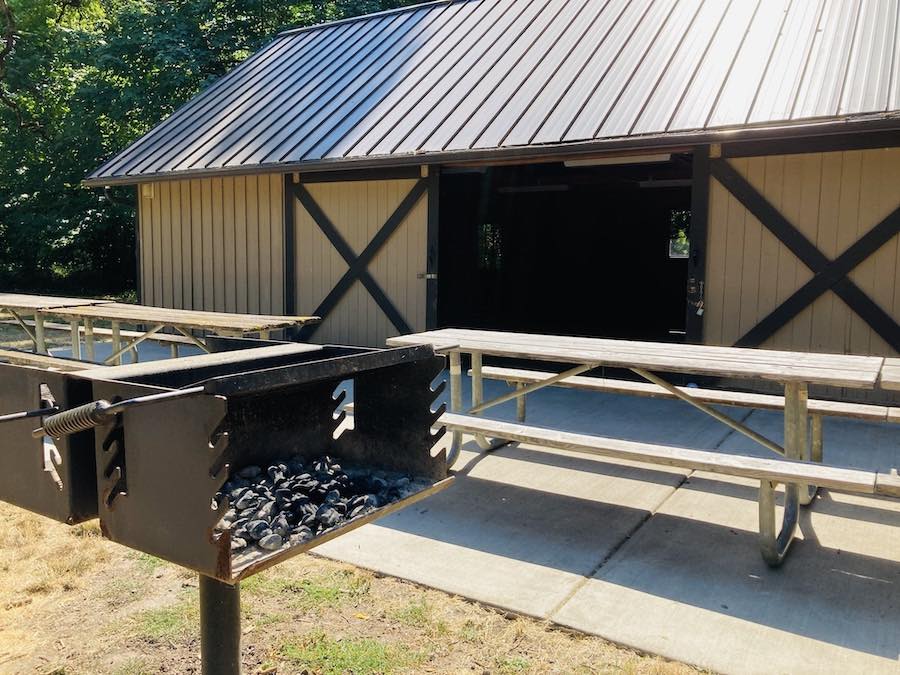 BBQ, picnic tables and barn door on group site meeting hall