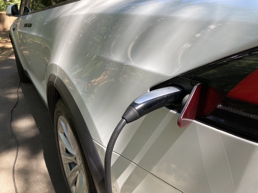 tesla with charger plugged in