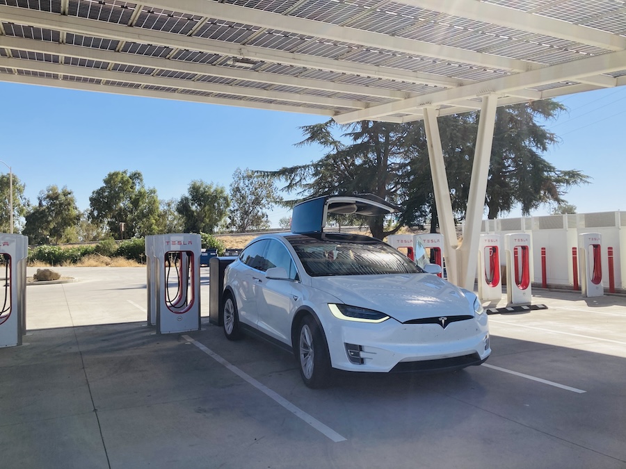 Tesla X charging under cover